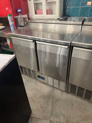 three refrigerators that are sitting in a kitchen