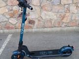 a scooter that is parked in front of a stone wall