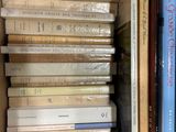 many books that are stacked in a box together