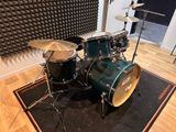 a drum set that is sitting on a rug in a room