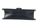 a black leather purse with a gold clasp on it