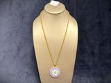 a white mannequin with a pink and yellow necklace on it