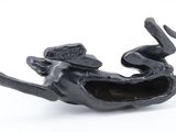 a black figurine of a dog with a hat on it ' s head