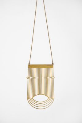 a gold necklace with a fringe hanging from it