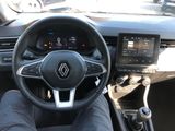 a picture of a person sitting in a car with their feet on the steering wheel