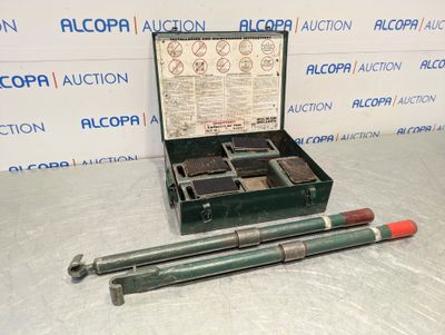 a box with a gun and two other items in it