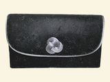 a black purse with a silver flower on it