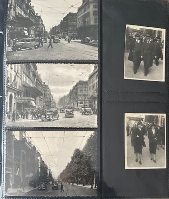 an old black and white photo of a group of people walking down a street