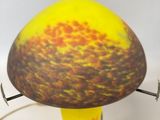 a yellow vase with a red and yellow design on it
