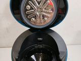 a close up of a blue and black coffee maker