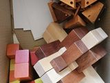 a cardboard box that has a bunch of wooden blocks in it