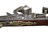 an old gun with a wooden handle and a brass plated handle