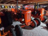 many tractors that are parked in the garage