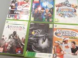four xbox game covers on a table