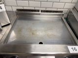 a metal grill top with a number on it in a kitchen