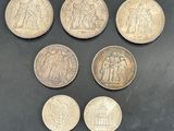 six different types of coins on a black surface