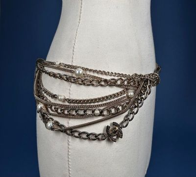 an image of a mannequin with chains and pearls on it