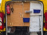 a yellow van with a box in the back of it