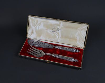 silverware in a box with a red velvet lining on a black surface