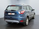 the rear end of a blue ford escape parked in a garage