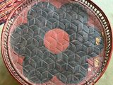a basket on the floor with a red dot on it
