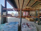 many bags of food sitting on the shelves in the warehouse