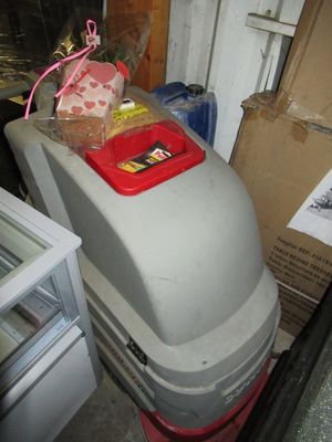 a trash can sitting on top of a trash can in a garage