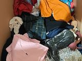 a cardboard box filled with clothes and other items