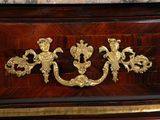 a wooden chest with a gold decoration on it