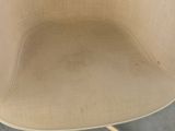 a beige chair with a wooden base and a black seat