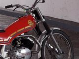 a red motorcycle that is parked in a garage