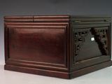 a small wooden box with carvings on top of it