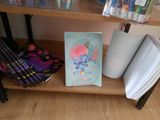 a picture of a book on a shelf next to other books