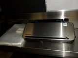 a metal device sitting on top of a metal table