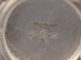 a close up of a silver plate with a logo on it