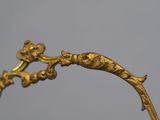 an image of a gold frame with a bird on it