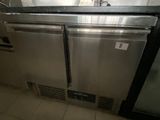 a stainless steel dishwasher and a refrigerator in a kitchen