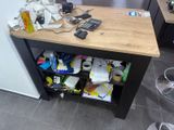 a desk with a lot of clutter on top of it