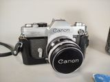 a camera that is sitting on a table next to a cell phone