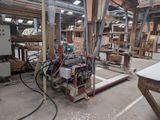 a machine that is working on a piece of wood