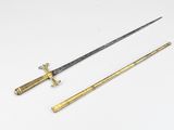 an image of two swords on a white surface with one sword in the foreground