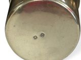 a metal object that is sitting on a white surface