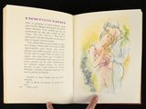 a person holding a book with a drawing of a man and a woman