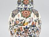 une image représentant un vase orné d'un oiseau et de fleurs