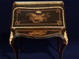 a black and gold painted desk with a dragon on it