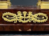 a wooden table with a gold decoration on it
