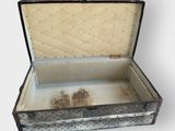 an old suitcase that is open on a white surface