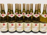 six bottles of wine are lined up in a row on a table