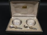 a silver plate and spoon set in a case