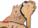 a wooden rocking horse with a clock on the back